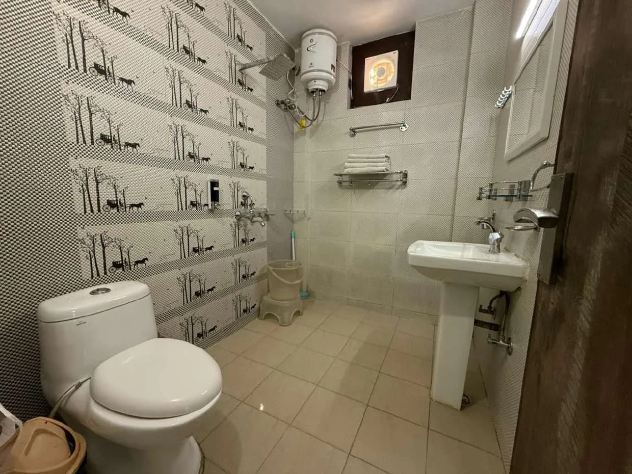 Bathroom with printed wall tiles, rain shower and towel rack