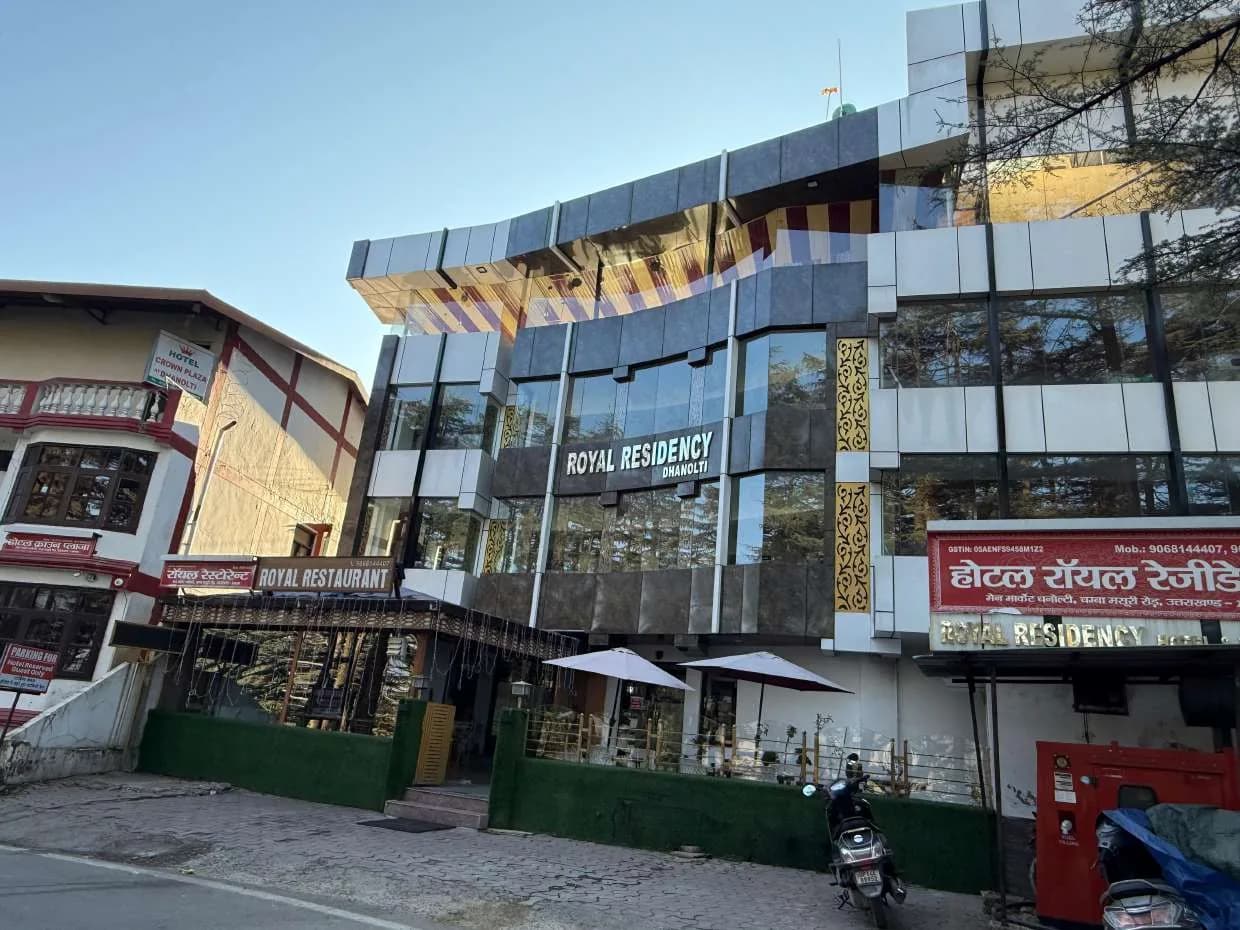 Front of Hotel Royal Residency with the restaurant entrance and outdoor umbrellas